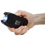 Compact stun gun with flashlight and battery indicator for self-defense.
